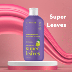 Purple ATTITUDE Kids Super Leaves shampoo and body wash bottle with pear illustration on a white and pink pedestal against a soft pink abstract background.