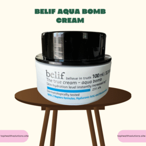 Belif Aqua Bomb Cream jar on round wooden table with white body, black lid, and silver accents; skincare product with Hyaluronic Acid & Niacinamide for deep hydration.
